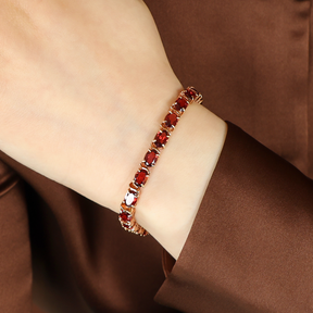 Model wears 9ct Yellow Gold Oval Shaped Garnet Tennis Bracelet