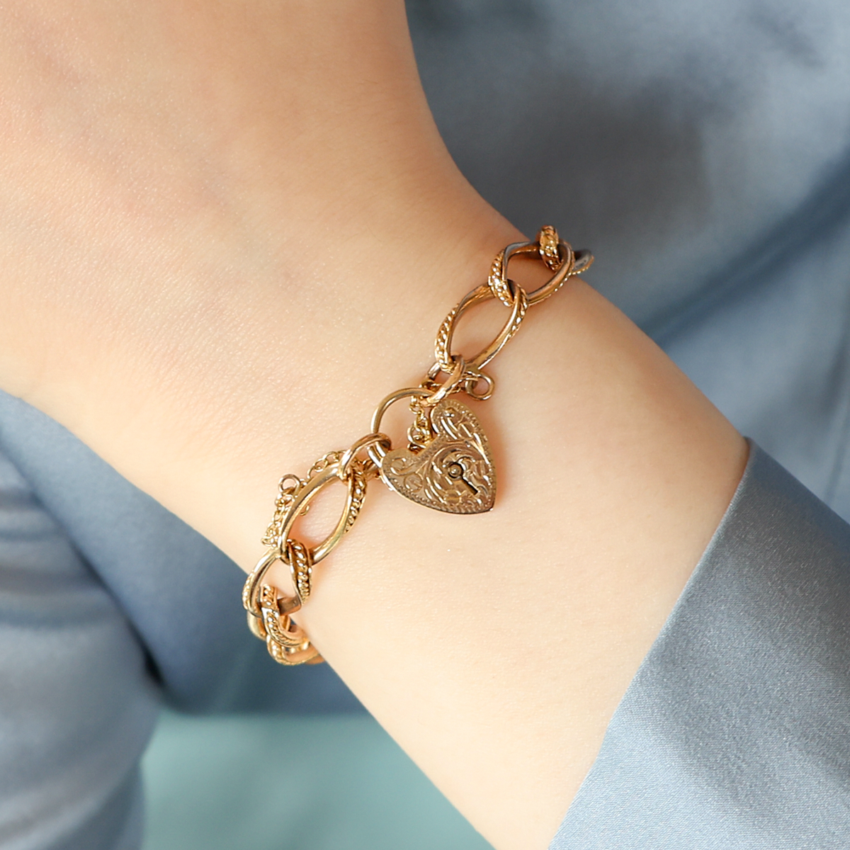 Model wears 9ct Yellow Gold Twisted Rope Edge Charm Bracelet