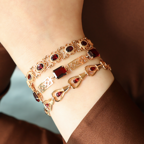 Model wears 9ct Yellow Gold Garnet Set Openwork Link Bracelet, 9ct Yellow Gold Victorian Style Garnet Bracelet & 9ct Yellow Gold Teardrop Garnet Set Bracelet