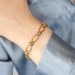 Model wears 9ct Yellow Gold Elongated Oval & Knot Link Charm Bracelet