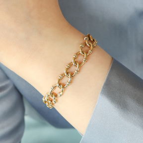 Model wears 9ct Yellow Gold Oval Ribbed Link Charm Bracelet