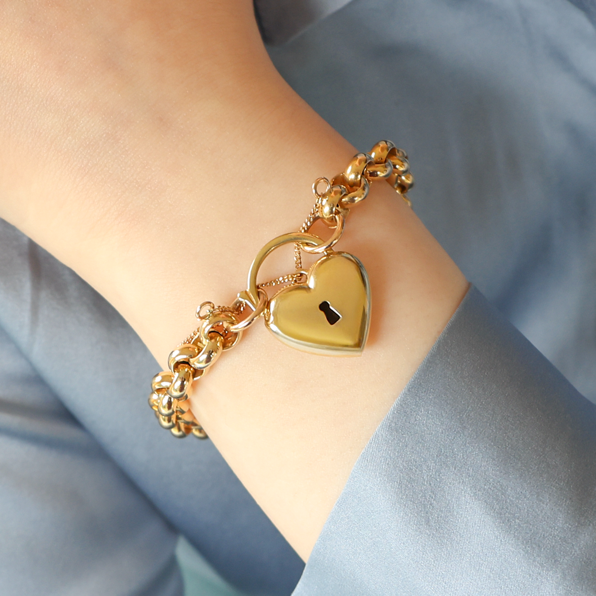 Model wears 9ct Yellow Gold Hollow Belcher with Puffed Heart Shaped Padlock Bracelet