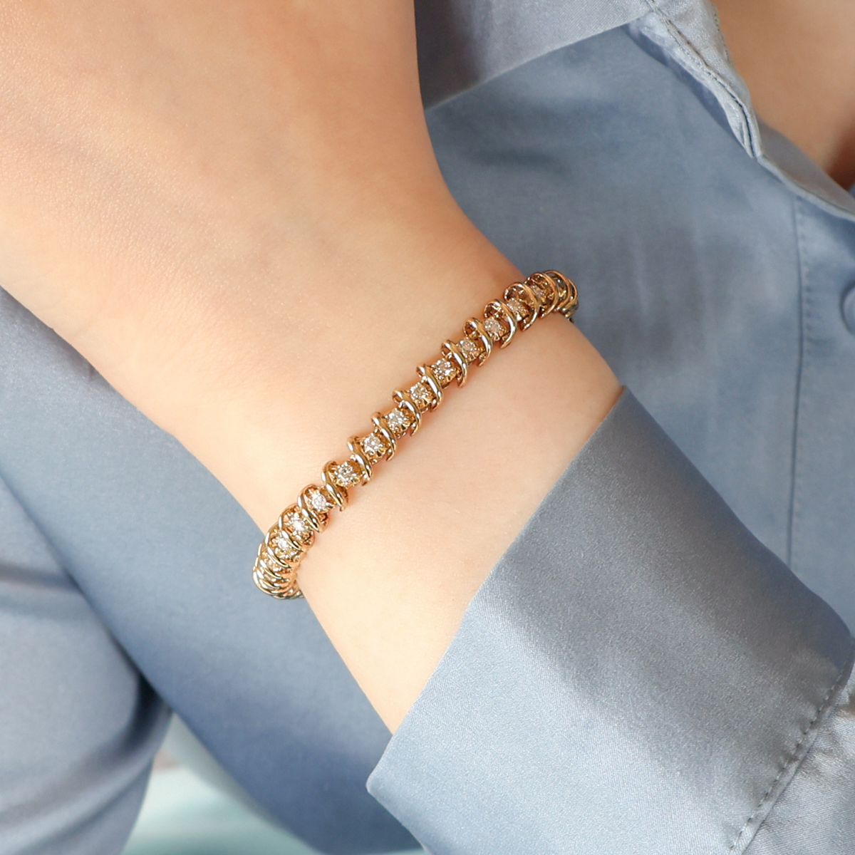 Model wears 9ct Yellow Gold Diamond Set Spiral Tennis Bracelet