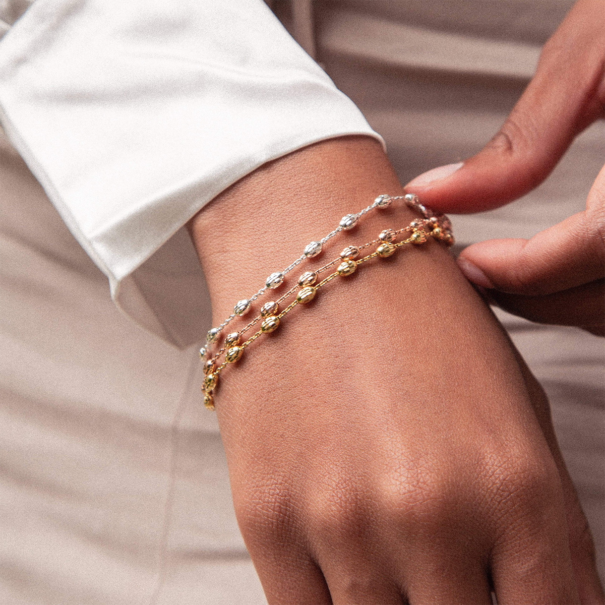 Model wears Sterling Silver 7” Diamond Cut Beaded Trace Link Bracelet