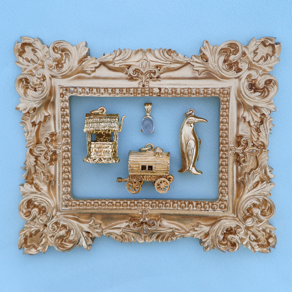 9ct Yellow Gold Wishing Well Charm, 9ct Yellow Gold Oval Shaped Rock Crystal Quartz Pendant, 9ct Yellow Gold Large Gypsy Fortune Teller Wagon Opening Charm, 9ct Yellow Gold Hollow Penguin Pendant By Georg Jensen