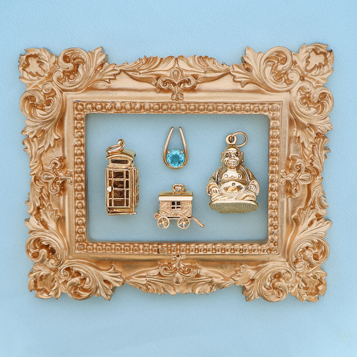 9ct Yellow Gold Large Telephone Box Opening Charm, 9ct Yellow Gold Apatite Horseshoe Pendant, 9ct Yellow Gold Gypsy Fortune Teller Wagon with Enamel Opening Charm & 9ct Yellow Gold Buddha Opening Charm