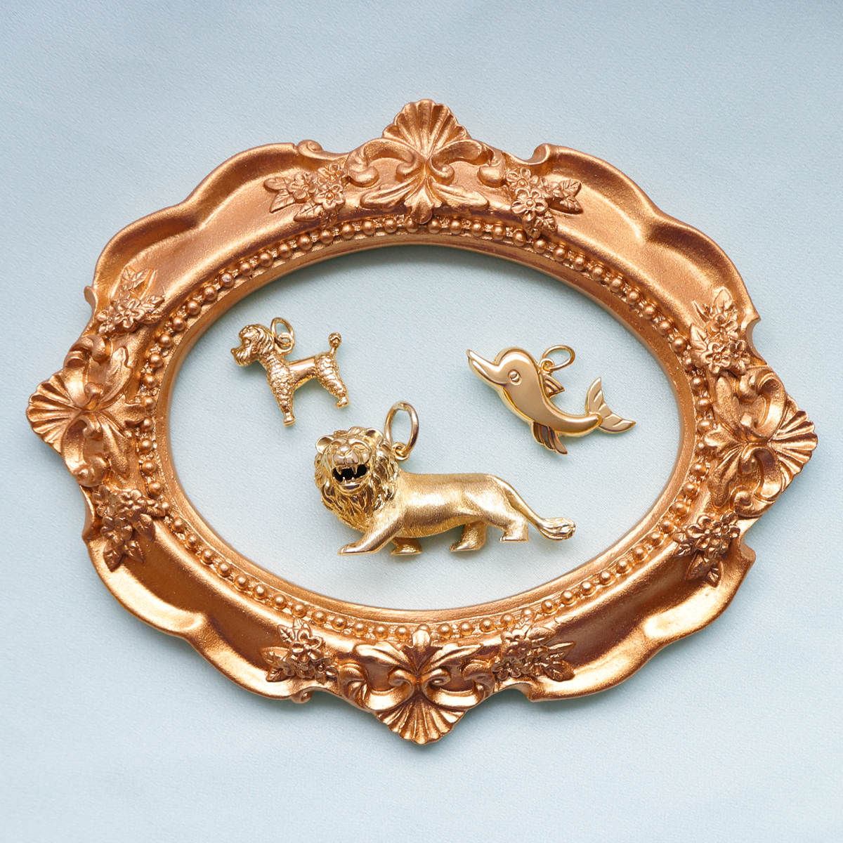 9ct Yellow Gold Poodle Charm, 9ct Yellow Gold Hollow Dolphin Pendant & 9ct Yellow Gold Lion Pendant
