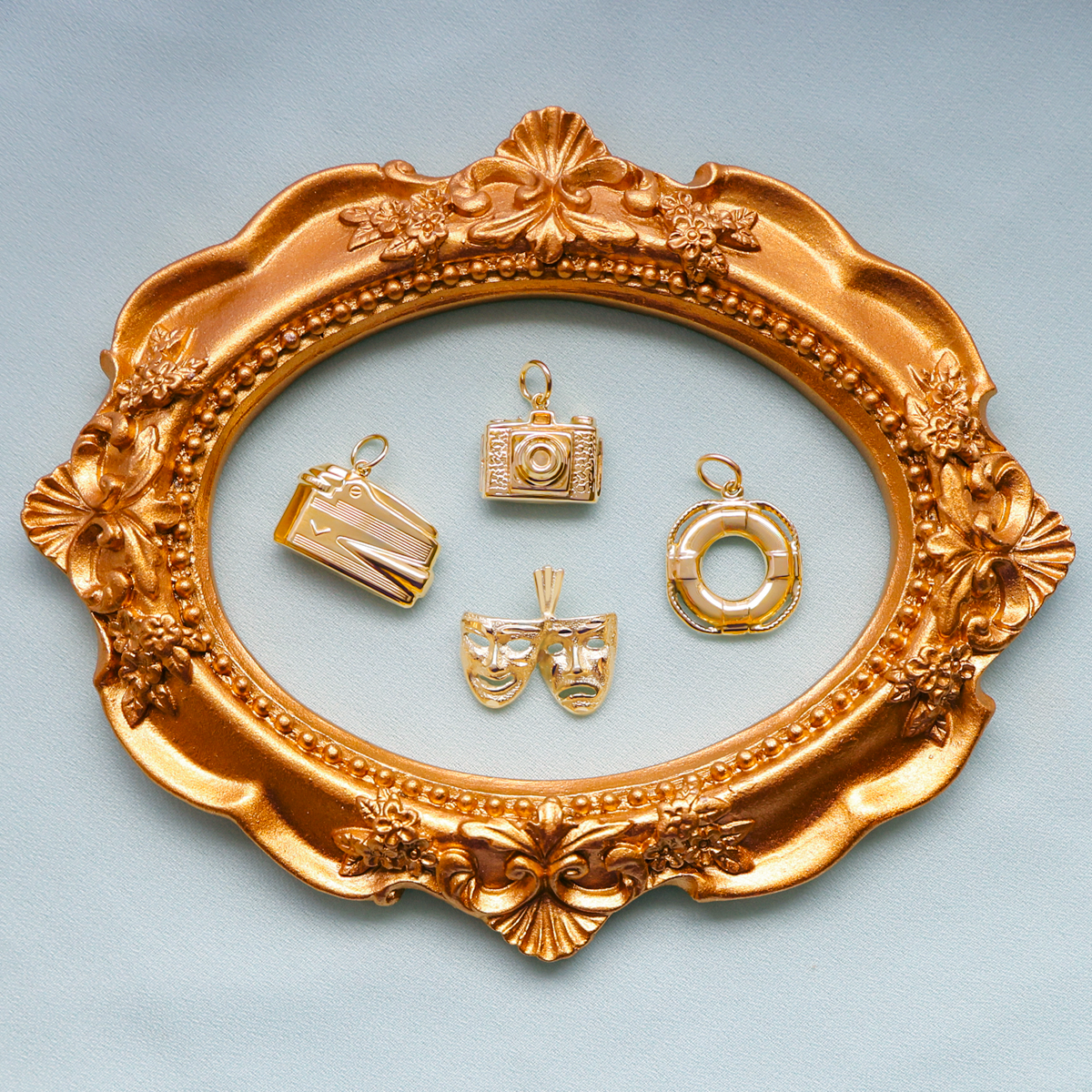 9ct Yellow Gold Hollow Lighter Charm, 9ct Yellow Gold Hollow Camera Charm, 9ct Yellow Gold Comedy & Tragedy Masks Pendant & 9ct Yellow Gold Hollow Lifebuoy Charm