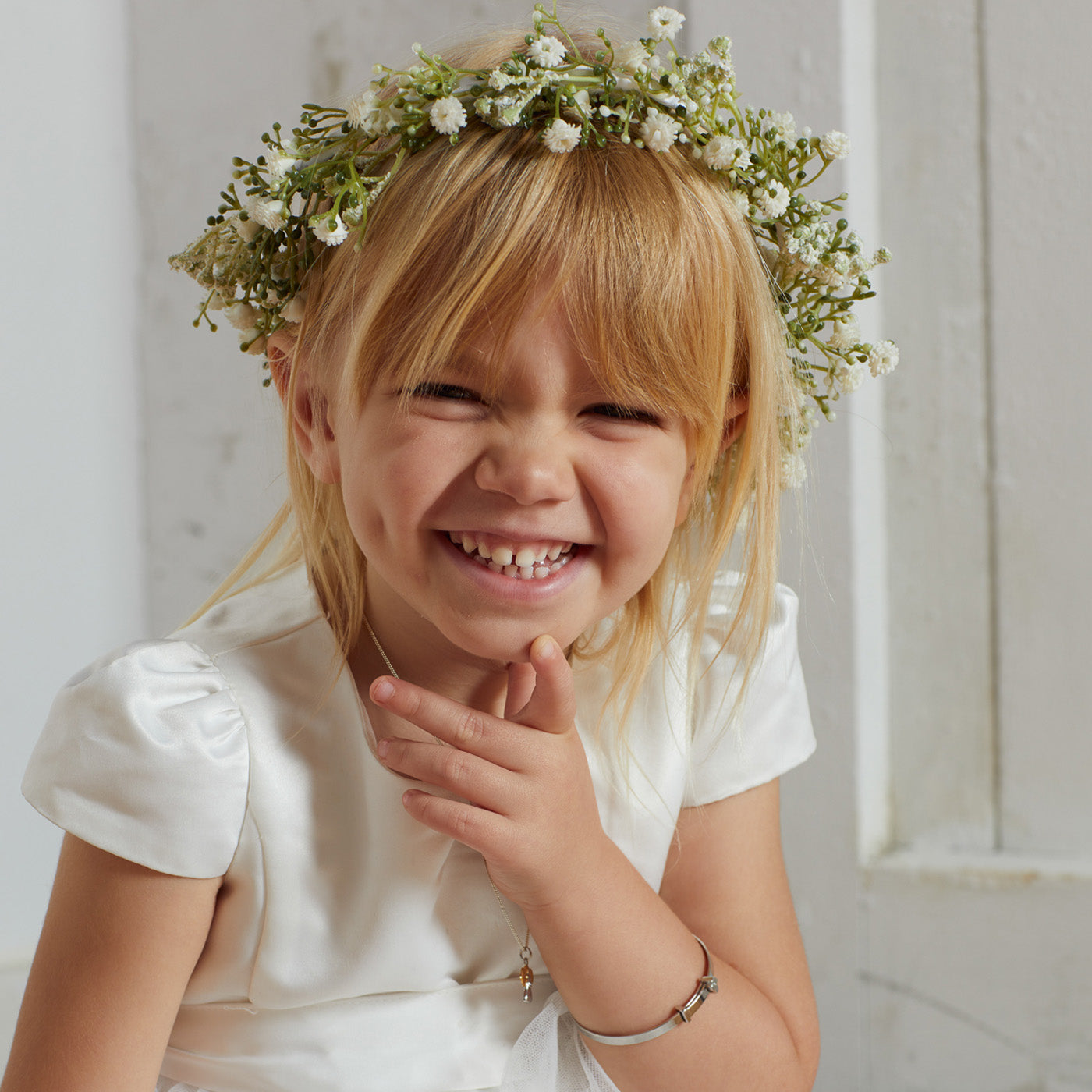 Child model wearing sterling silver bangle and necklace. 