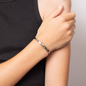 Model wears Recycled Sterling Silver Glow in the Dark Star & Moon Bangle with Diamond