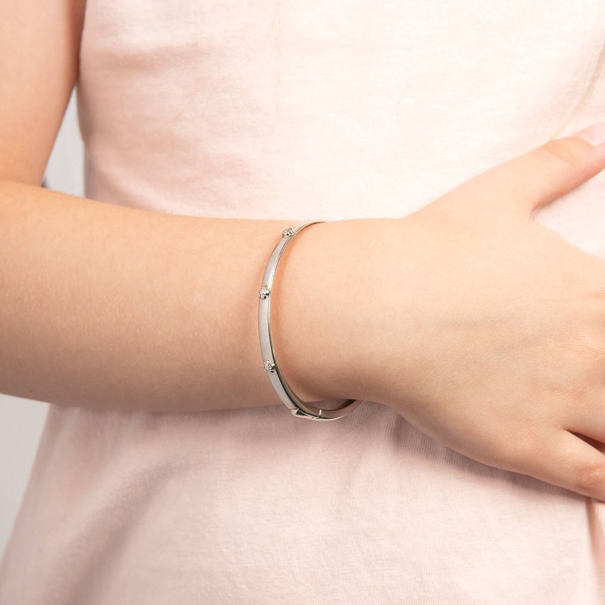 Model wears Recycled Sterling Silver Floral Hinged Maiden Bangle with Diamond