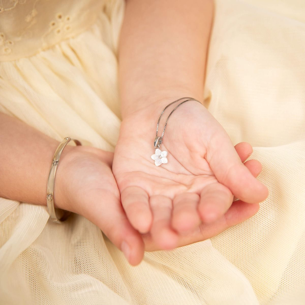 Model wears Recycled Sterling Silver Floral Hinged Maiden Bangle with Diamond