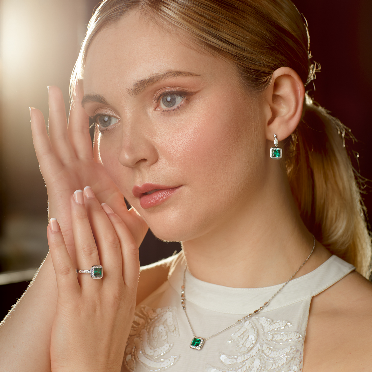 Model wears Sterling Silver Art Deco Stye Green Cubic Zirconia Pave Set Ring, Earrings & Necklace