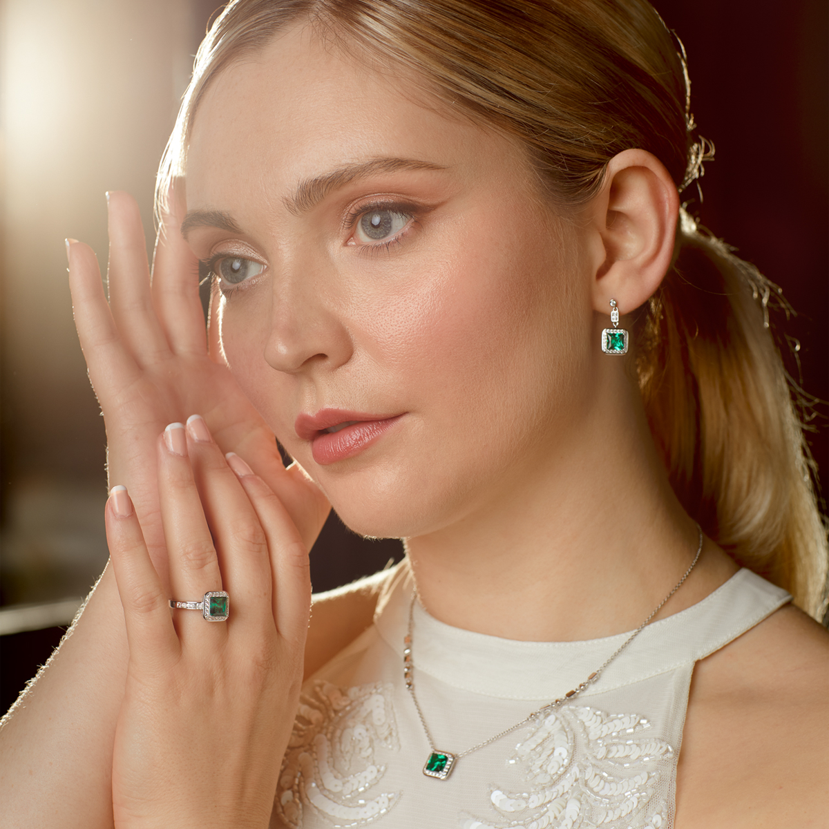 Model wears Sterling Silver Art Deco Style Green Cubic Zirconia Pave Set Drop Earrings, Ring & Necklace