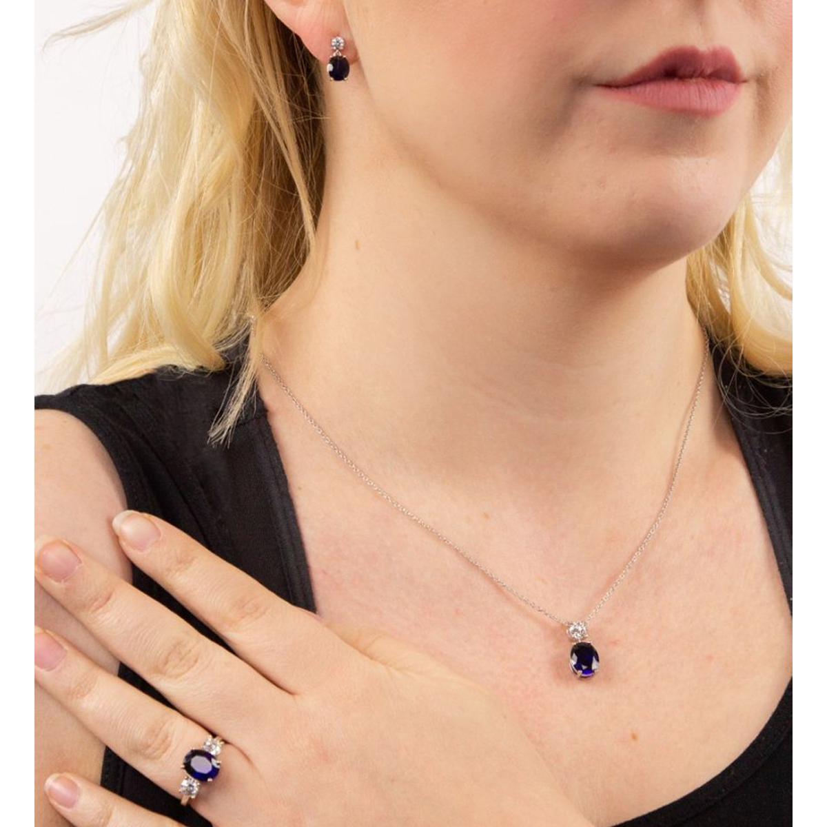 Model wears Sterling Silver Oval Shaped Blue Cubic Zirconia Drop Earrings, Ring & Pendant
