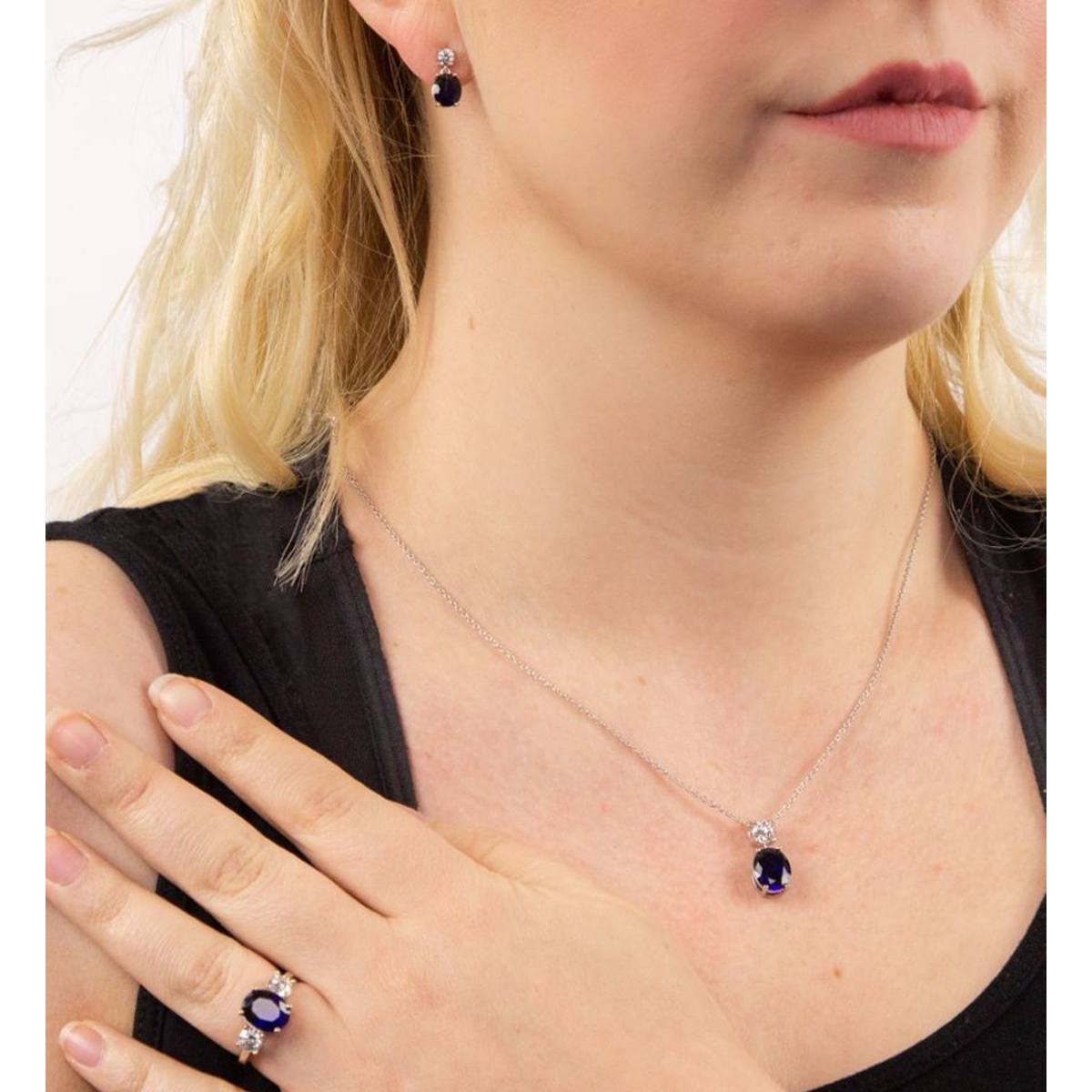 Model wears Sterling Silver Oval Shaped Blue Cubic Zirconia Drop Pendant & Chain, Earrings & Ring