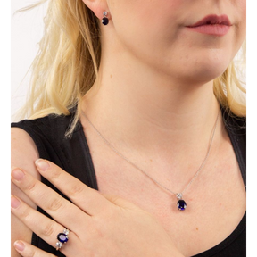 Model wears Sterling Silver Oval Shaped Blue Cubic Zirconia Drop Pendant & Chain, Earrings & Ring