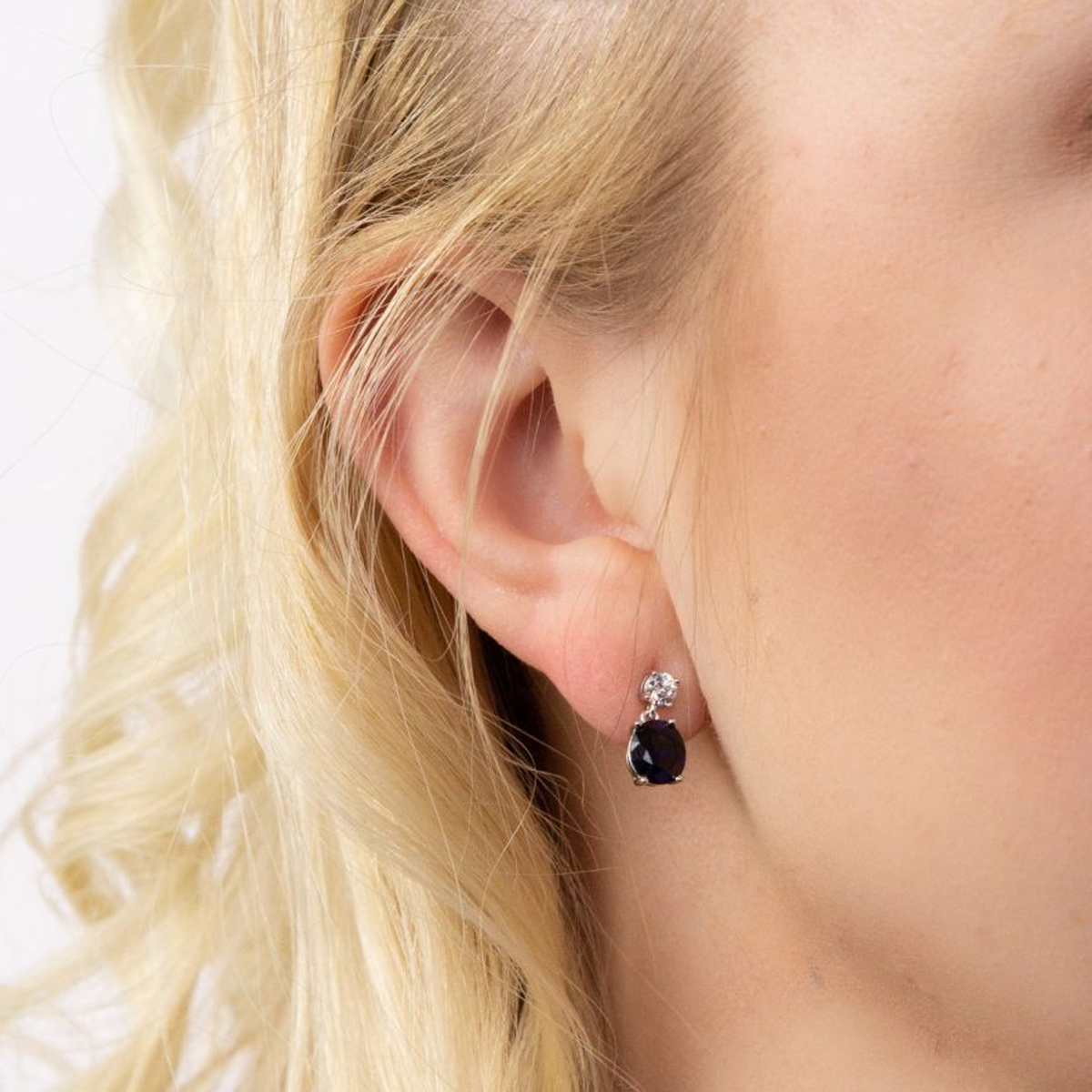 Model wears Sterling Silver Oval Shaped Blue Cubic Zirconia Drop Earrings