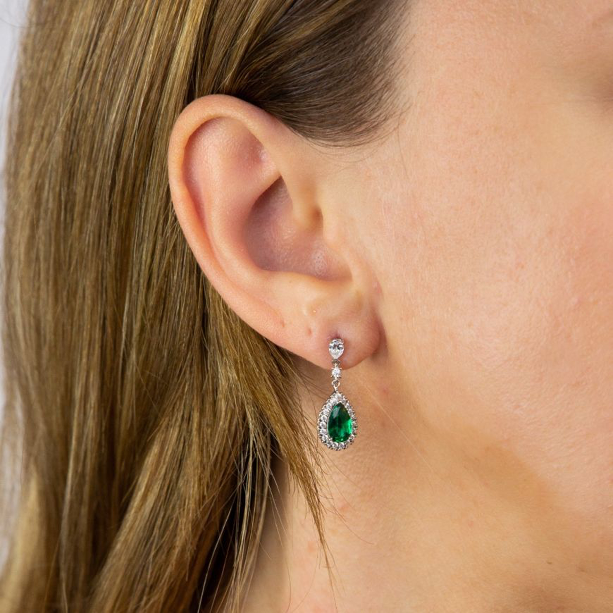Model wears Sterling Silver Teardrop Green Cubic Zirconia With Pave Surround Drop Earrings