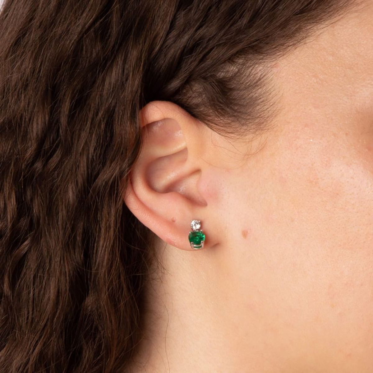Model wears Sterling Silver Oval Shaped Green Cubic Zirconia Drop Earrings