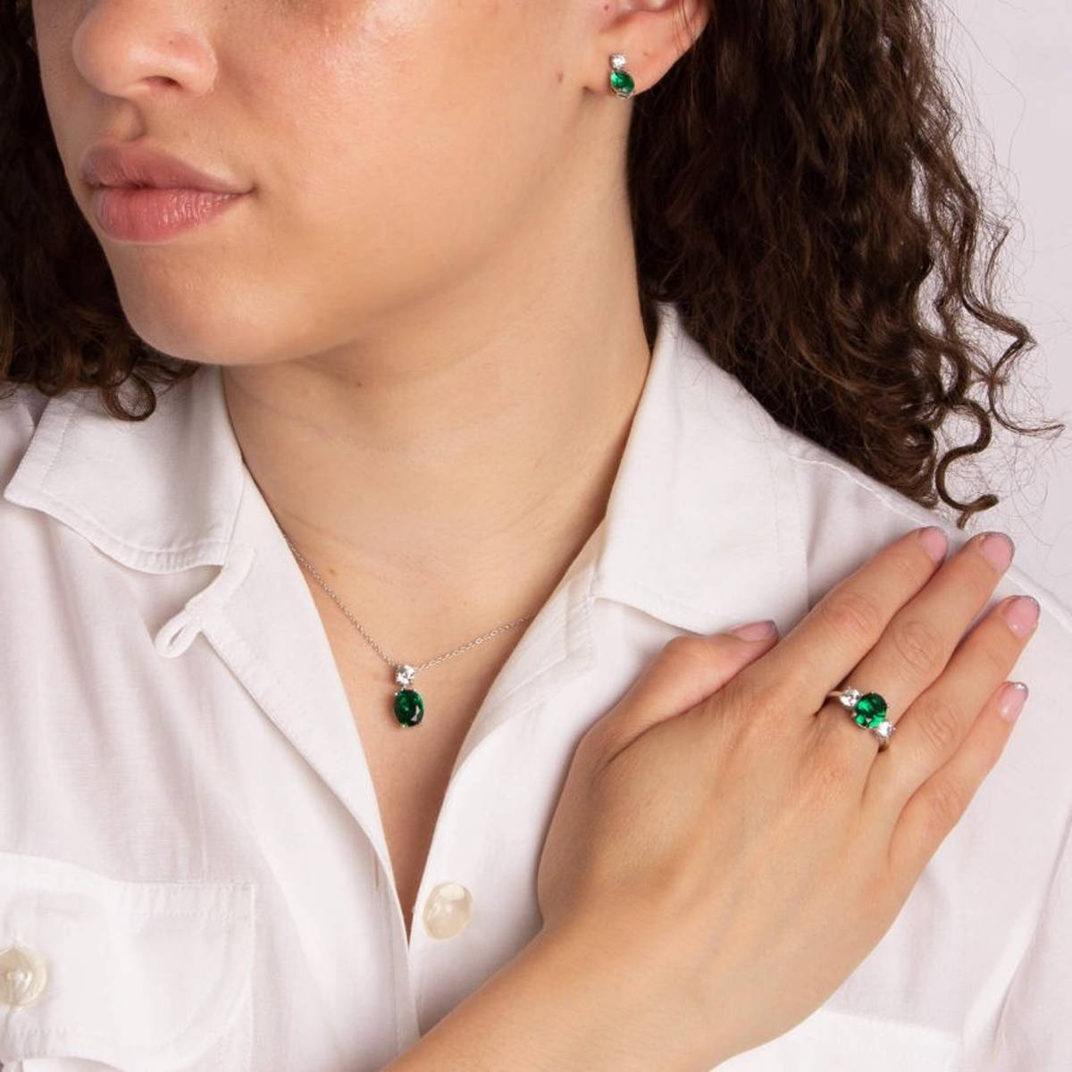 Model wears Sterling Silver Oval Shaped Green Cubic Zirconia Drop Pendant & Chain, Earrings & Ring