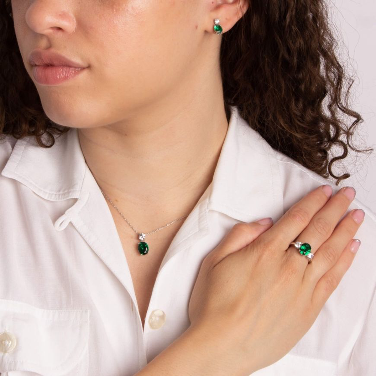 Model wears Sterling Silver Oval Shaped Green Cubic Zirconia Drop Earrings, Ring & Pendant