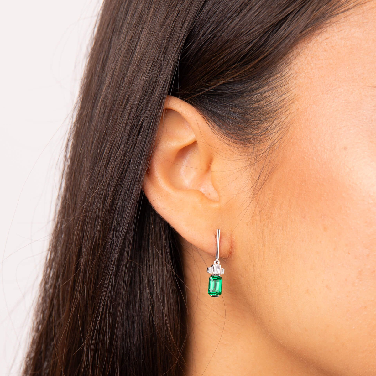 Model wears Sterling Silver Emerald Cut Green Cubic Zirconia Drop Earrings