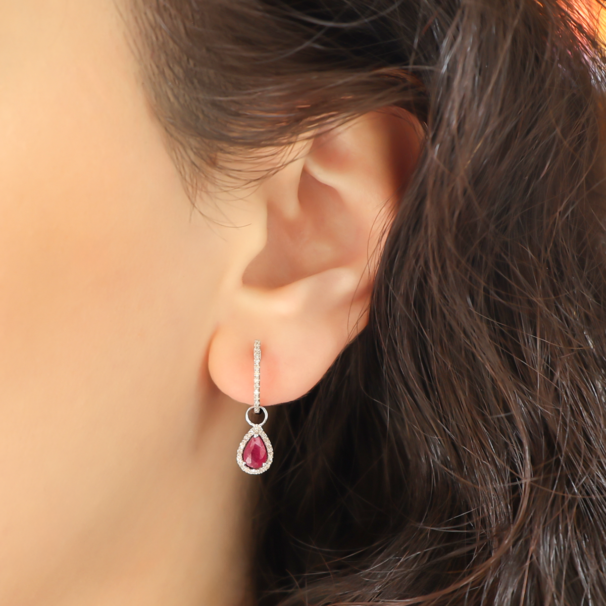 Model wears 9ct White Gold Pear Shaped Ruby & Diamond Hoop Earrings