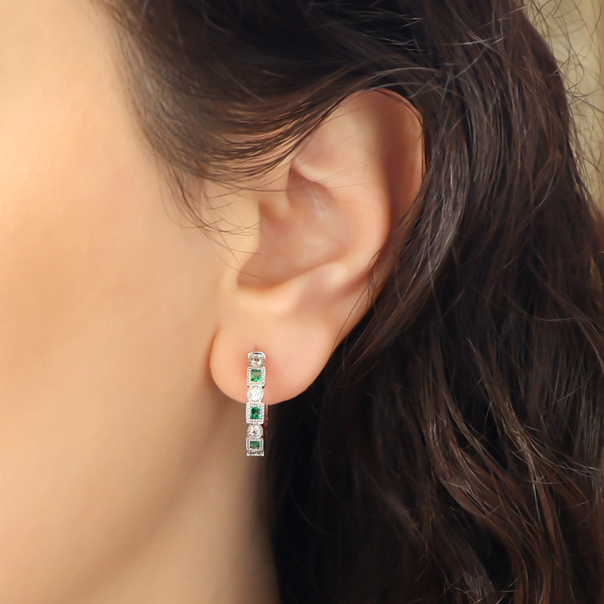 Model wears 9ct White Gold Emerald & Diamond Half Set Hoop Earrings
