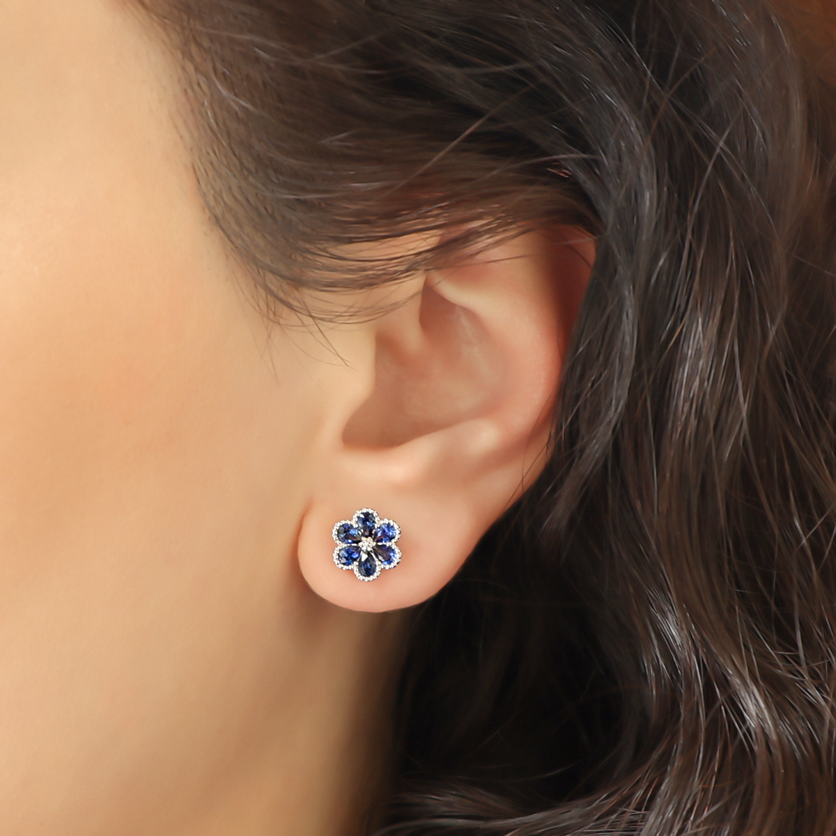 Model wears 18ct White Gold Sapphire & Diamond Flower Stud Earrings