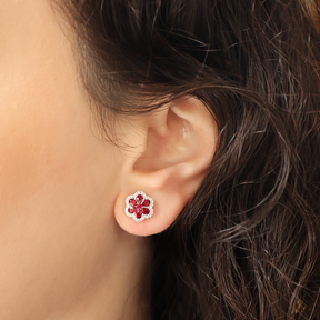 Model wears 18ct White Gold Ruby & Diamond Flower Stud Earrings