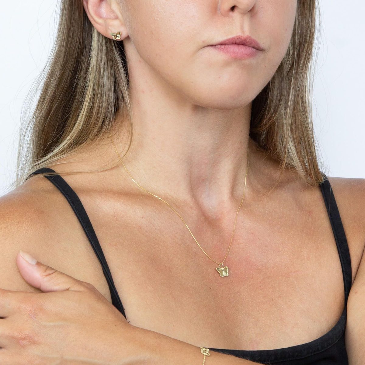 Model wears 9ct Yellow Gold Diamond Cut Butterfly Stud Earrings & Pendant