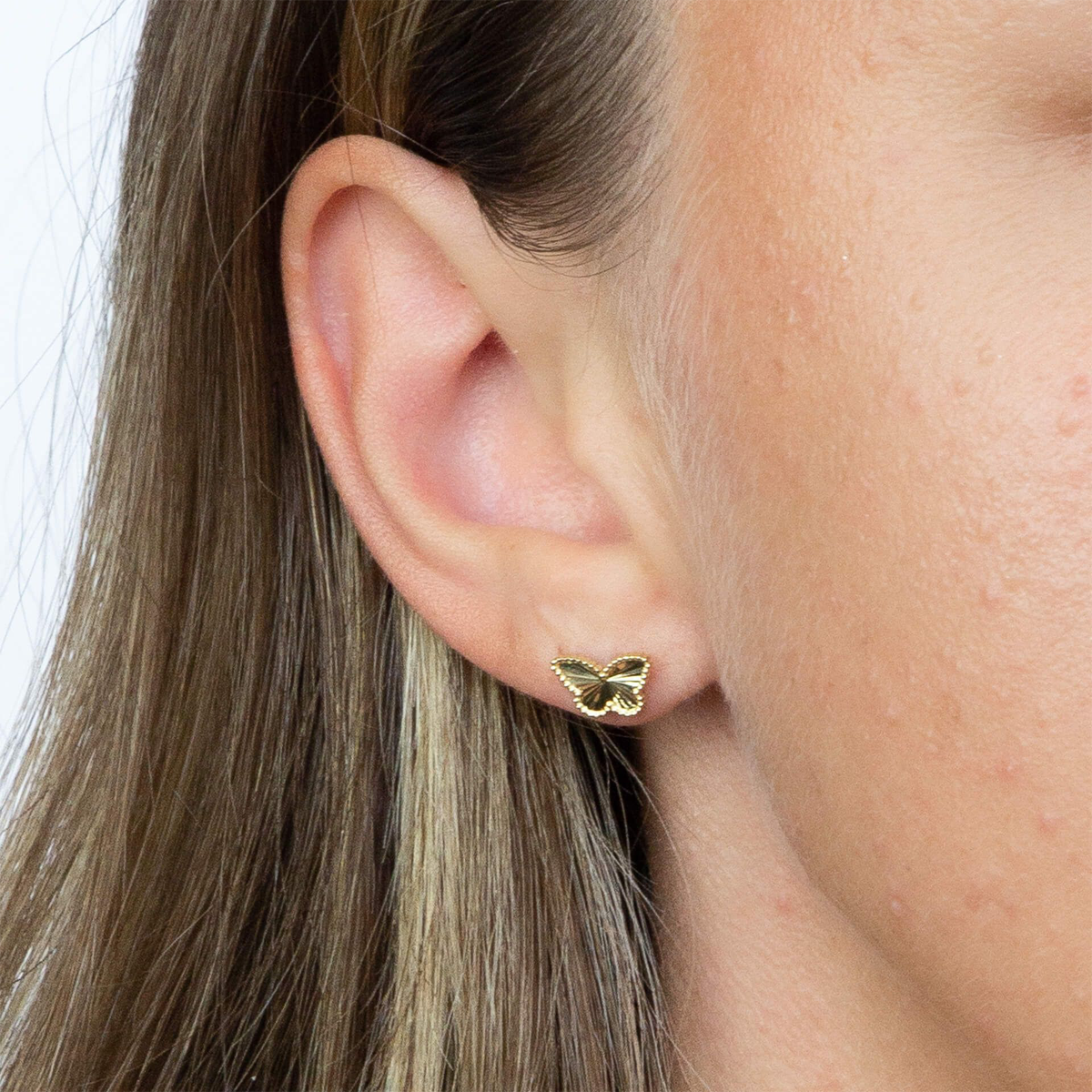 Model wears 9ct Yellow Gold Diamond Cut Butterfly Stud Earrings