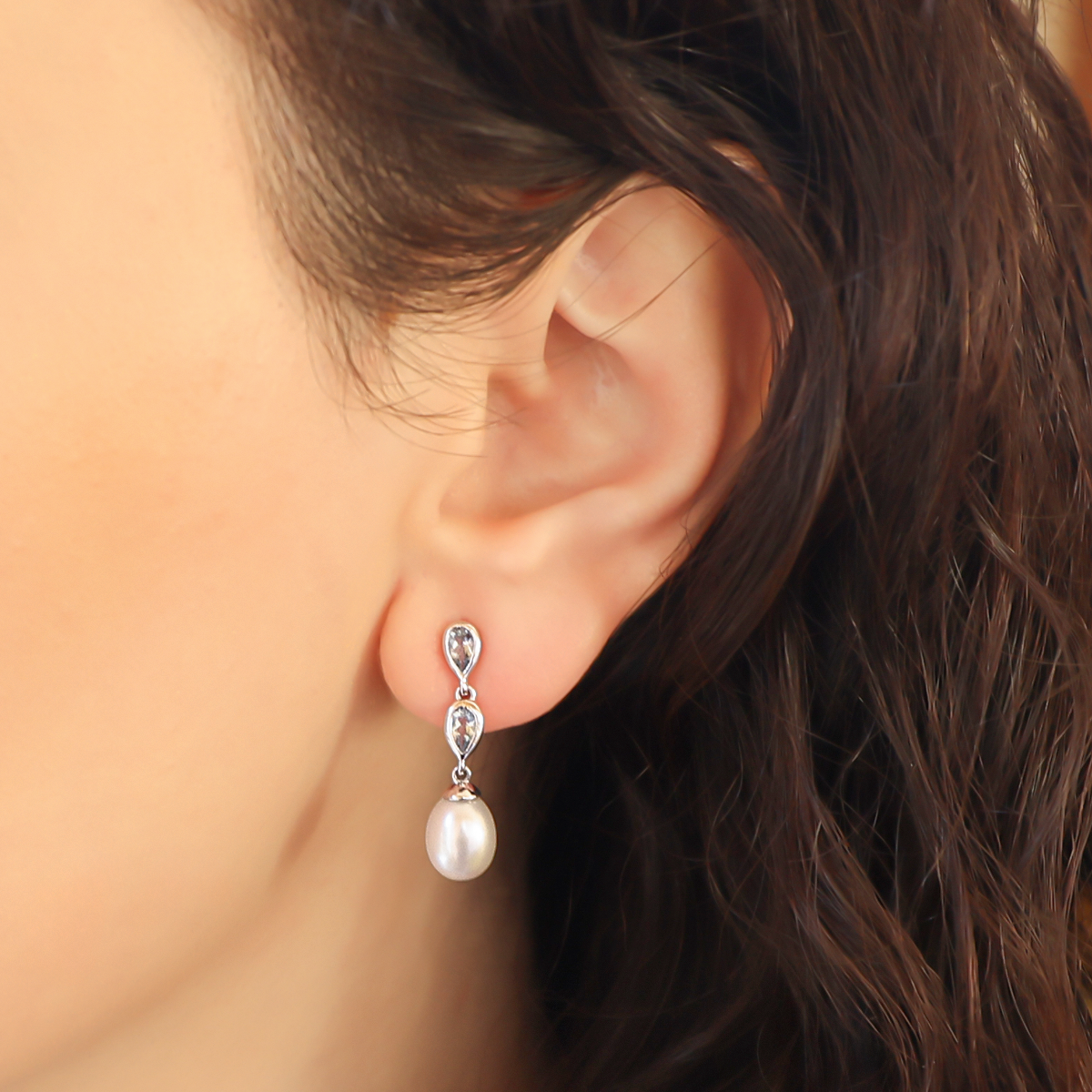 Model wears 9ct White Gold Pearl & Aquamarine Double Drop Earrings