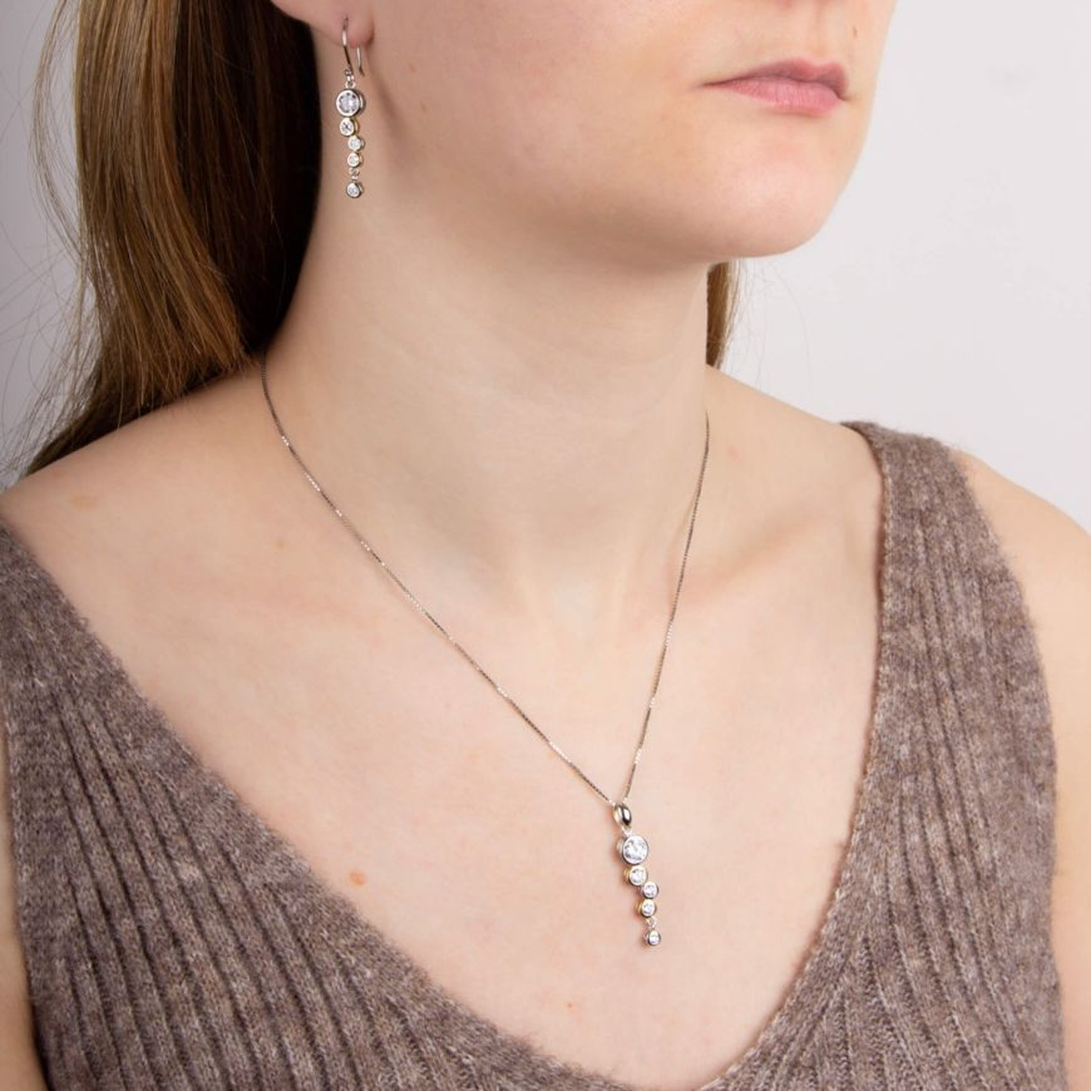 Model wears Sterling Silver & Gold Plated Cubic Zirconia Bubble Drop Pendant & Chain & Earrings