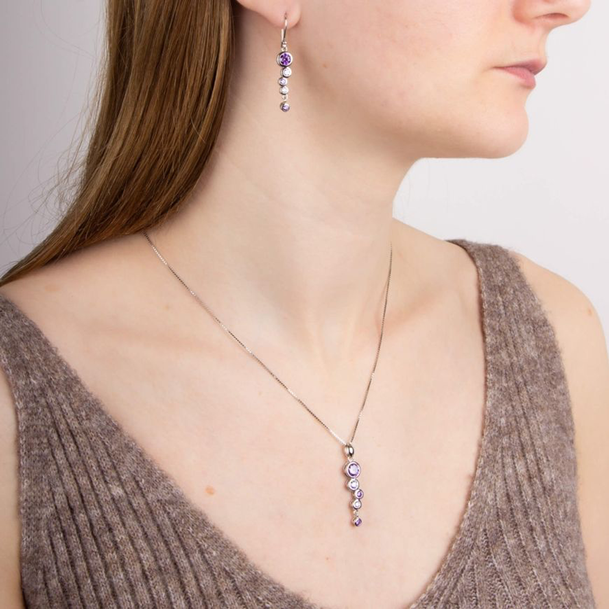 Model wears Sterling Silver Purple Cubic Zirconia Bubble Drop Pendant & Chain & Earrings