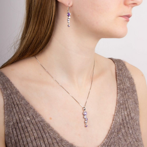 Model wears Sterling Silver Purple Cubic Zirconia Bubble Drop Earrings & Pendant & Chan