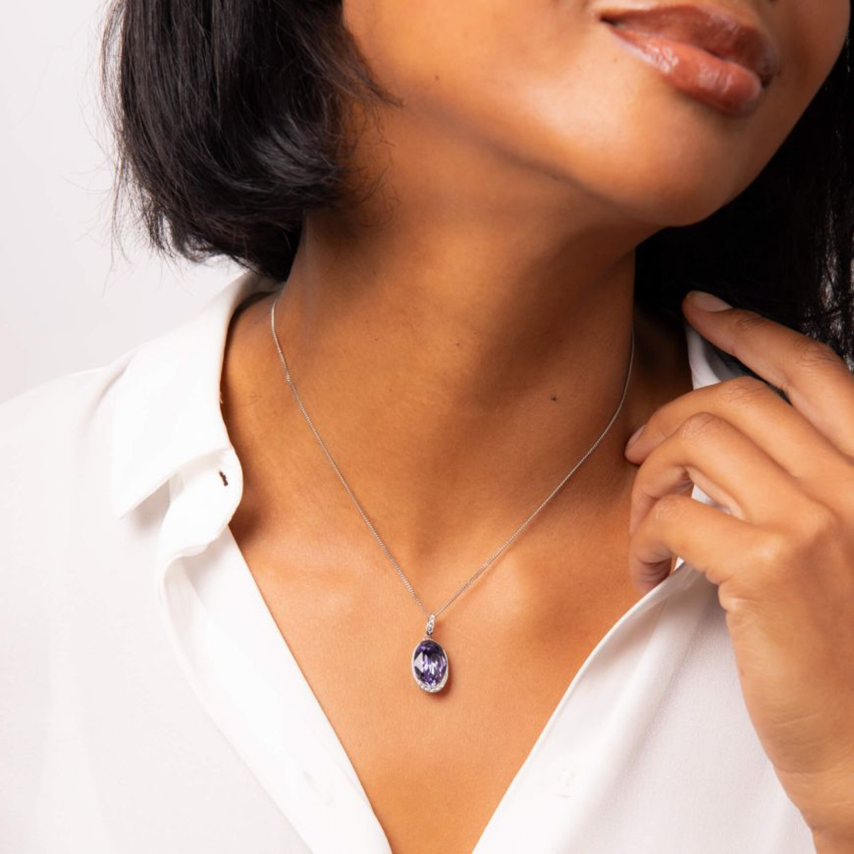 Model wears Sterling Silver Oval Purple Crystal With Cubic Zirconia Wave Pendant & Chain