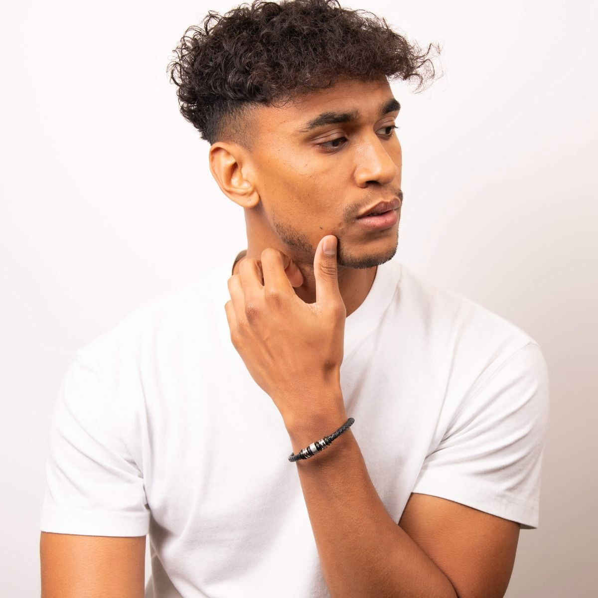 Model wears Stainless Steel Black Leather Disc Bracelet