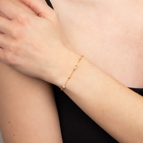 Model wears 9ct Yellow Gold Freshwater Pearl Trace Link Station Bracelet