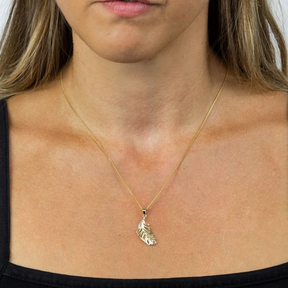 Model wears 9ct Yellow & White Gold Feather Pendant