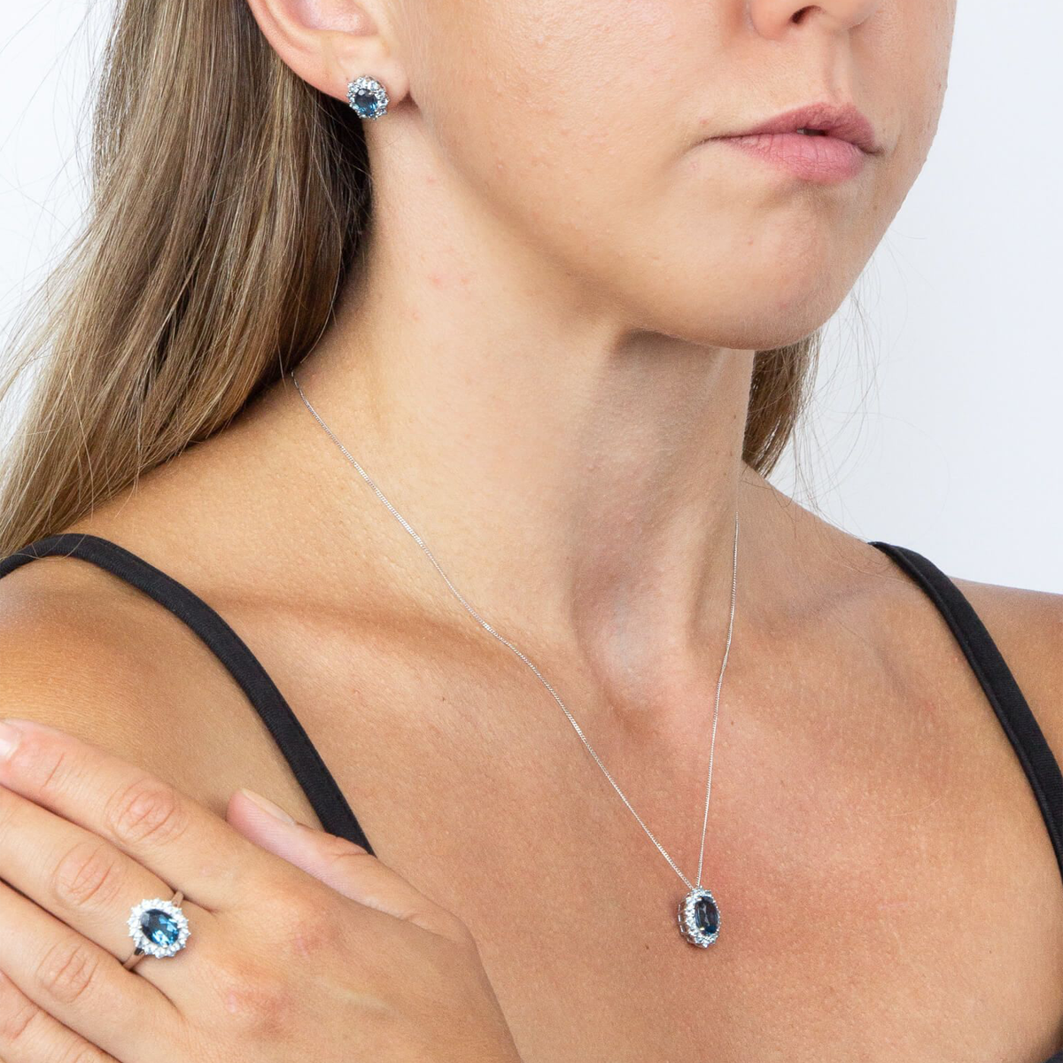 Model wears 9ct White Gold Blue Topaz Cluster Stud Earrings, Ring & Pendant