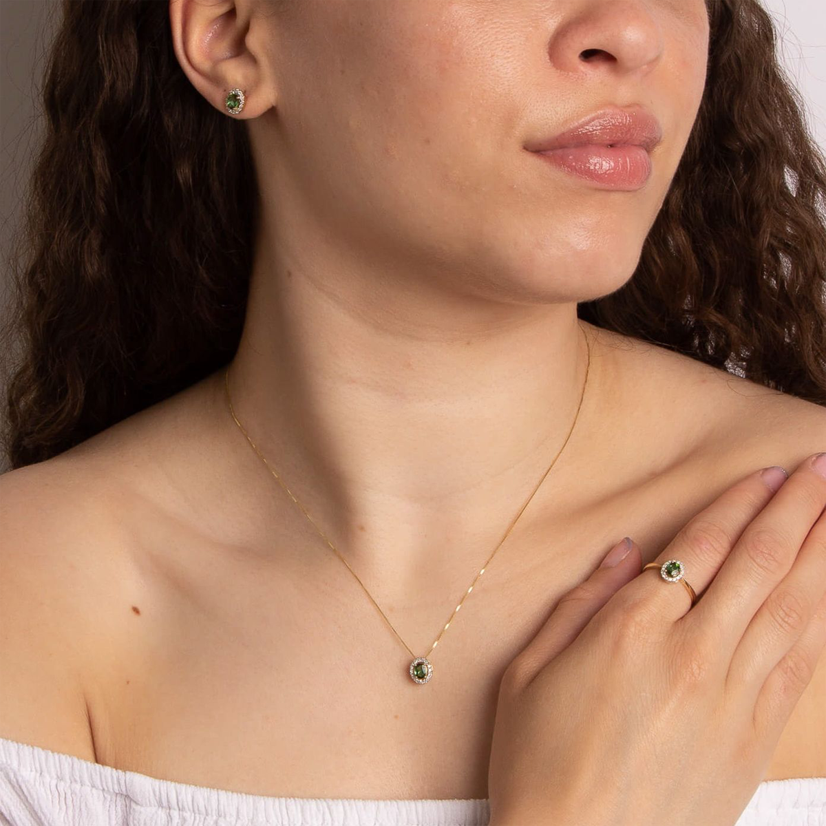 Model wears 9ct Yellow Gold Green Tourmaline & Diamond Halo Pendant, Earrings & Ring