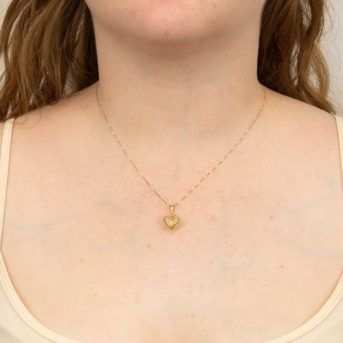 Model wears 9ct Yellow Gold Caged Heart Pendant