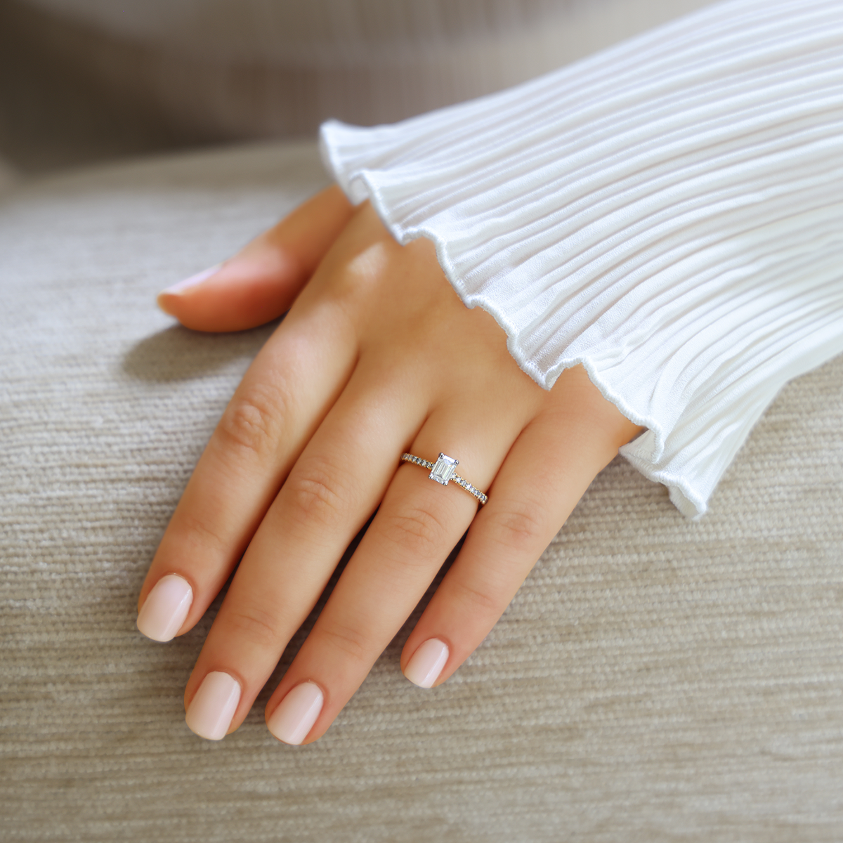 Model wears 18ct Two Colour Gold Emerald Cut Diamond Solitaire & Shoulder 0.73ctw Ring