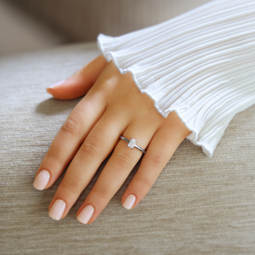 Model wears Platinum Emerald Cut Diamond Solitaire 0.65ct Ring