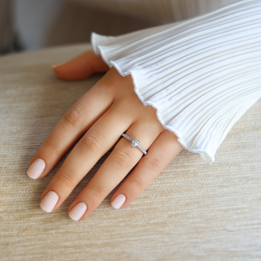 Model wears Platinum Pear Cut Diamond Solitaire & Shoulders 0.65ctw Ring