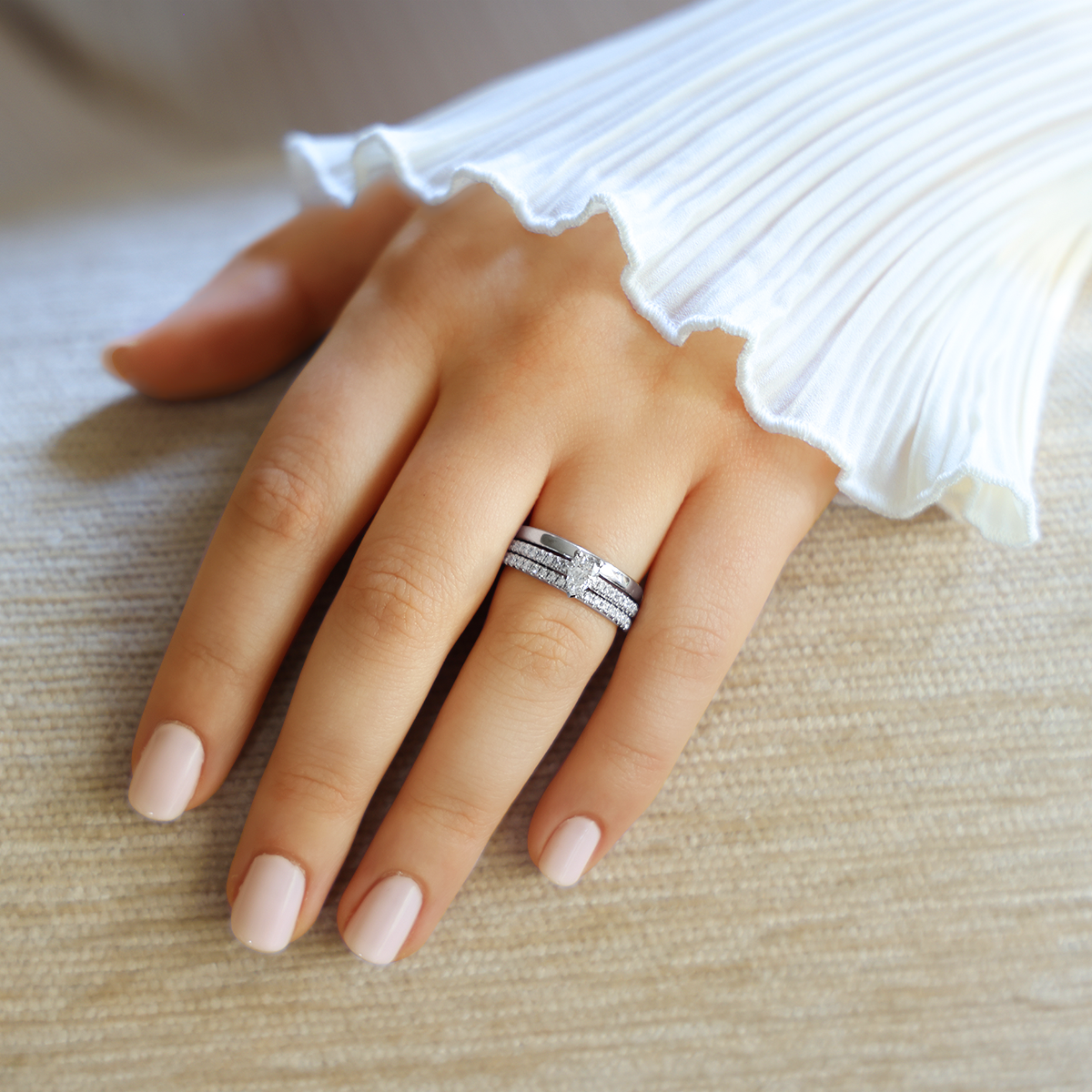 Model wears Platinum Pear Cut Diamond Solitaire & Shoulders 0.65ctw Ring with Eternity & Wedding Band