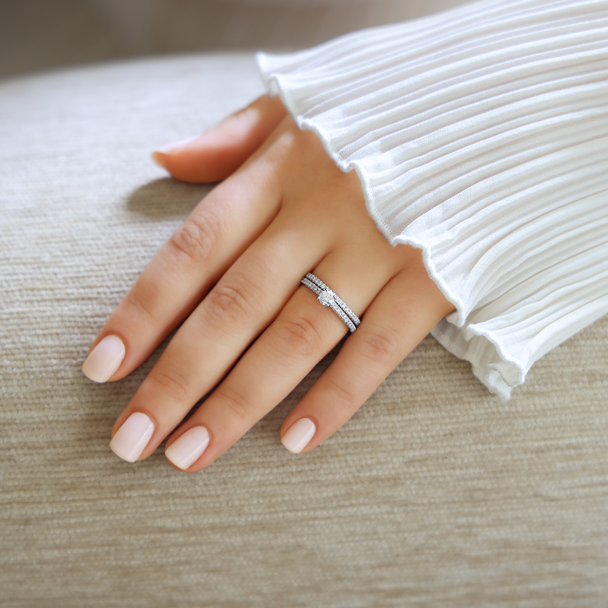 Model wears Platinum Round Brilliant Cut Diamond Solitaire & Shoulder 0.48ctw Ring with Matching Eternity Ring