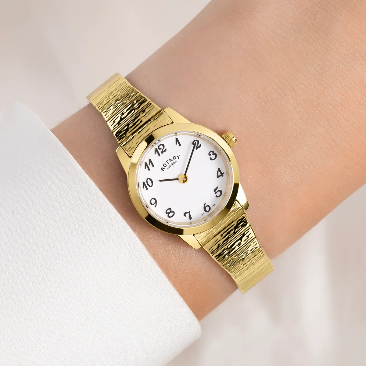 Model wears Rotary Heritage Altera, Round White Dial with Textured Gold Plated Bracelet LB00762/01